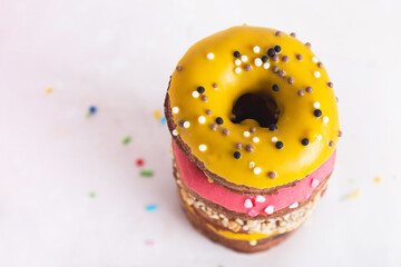 Colorful sweet donuts stack on table. Delicious dessert, food background. Top view, flat lay, copy...