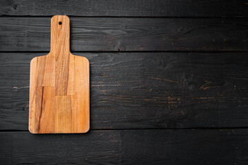 Cutting board, on black wooden table background, top view flat lay , with copy space for text or your product