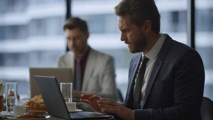 Business lawyer sitting cafe working online on laptop computer in cafe workplace