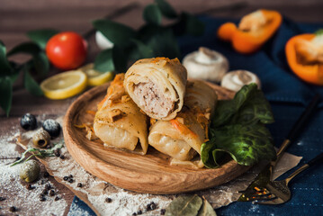Meat in cabbage on a wooden plate