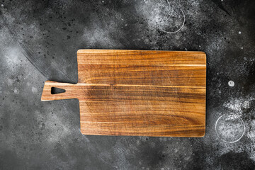 Used bamboo chopping board empty for empty for copy space for text or food, top view flat lay , on black dark stone table background