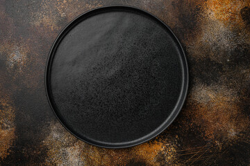 Black plate, on old dark rustic table background
