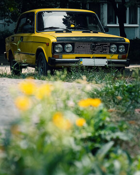 Yellow Car In The Parking Lot Near The House