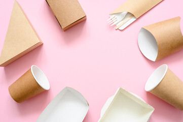 A set of disposable eco-friendly tableware around the empty space in the center of the frame. Free space for advertising. View from above