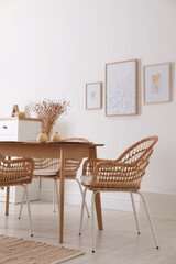 Dining room interior with wooden table and wicker chairs