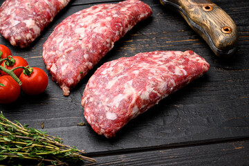 Homemade meat beef cutlets, on black wooden table background