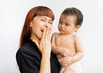 Happy mother with her baby on isolated white background. Mom and son waving hands looking at camera...