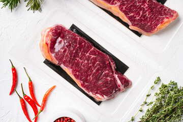 New-York steak pack for the new year, on white stone table background, top view flat lay