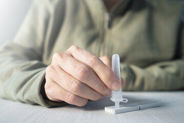 Person performs testing at home with sars cov 2 antigen test card kit.