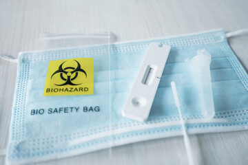 Test result of covid19 corona virus on sars cov 2 antigen home testing kit card. Biohazard logo on...