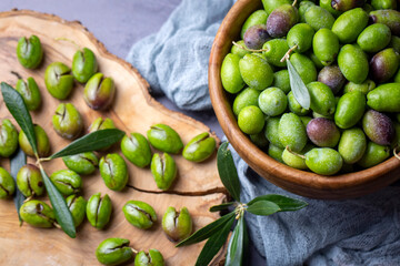 Homemade crushing olive making. Fresh green olives are breaking one by one. Crushing olives with stone. Preparing pickled olives in Turkish style. (Turkish name; kirma zeytin)