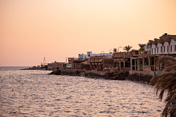 Beautiful sunset in Dahab seaside, cafes and orange sky in Dahab, Egypt