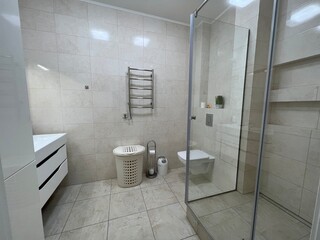 bathroom with toilet and shower. White tile