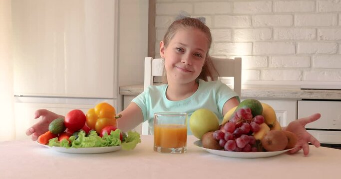 little girl wants to eat vegetables and fruits. the child enjoys fresh fruits and vegetables. girl showing thumbs up. copy space