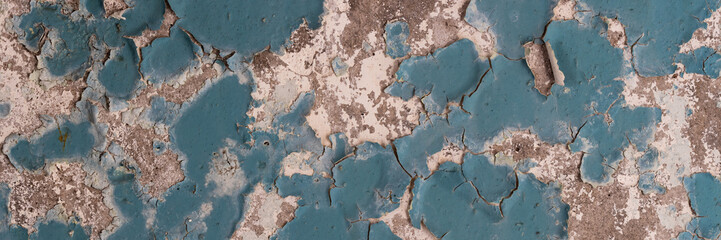 Fototapeta na wymiar Peeling paint on the wall. Panorama of a concrete wall with old cracked flaking paint. Weathered rough painted surface with patterns of cracks and peeling. Wide panoramic grungy texture for background