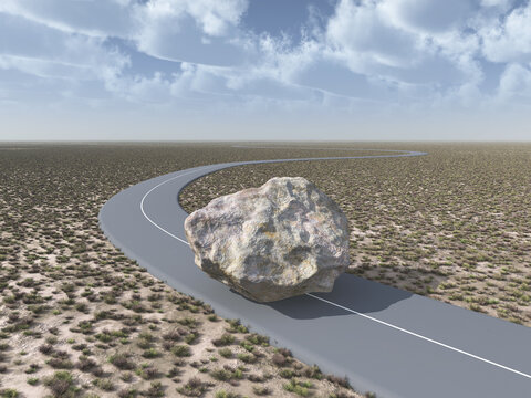 Felsbrocken versperrt den Weg auf einer Landstraße