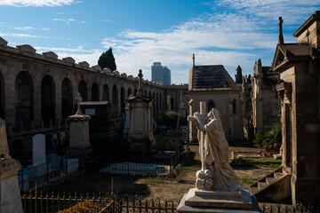 Fototapeta premium View of Poble Nou cemetery on a sunny day with historical statues and graves, with crosses and christian symbols and flowers. concept of death in Barcelona, Spain - 1 November 2021