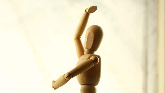 a wooden man whirls in place. dancing puppet