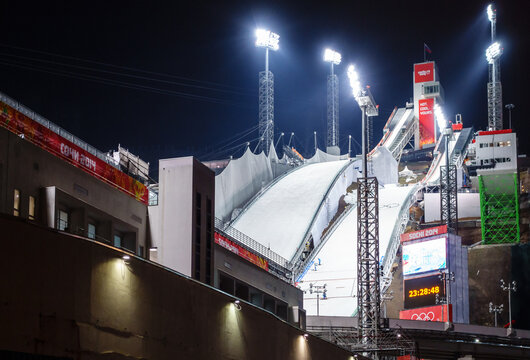 Sochi, Russia - February 12, 2014: Ski Jumping At The 2014 Winter Olympics Was Held At RusSki Gorki Jumping Center In Krasnaya Polyana. Night View With Sports Illumination Of Ski Jumps