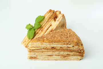 Pieces of honey cake on white background