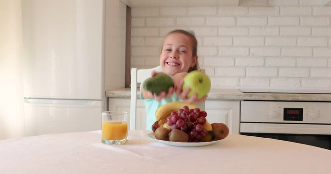 little girl wants to eat vegetables and fruits. the child enjoys fresh fruits and vegetables. girl showing thumbs up. copy space