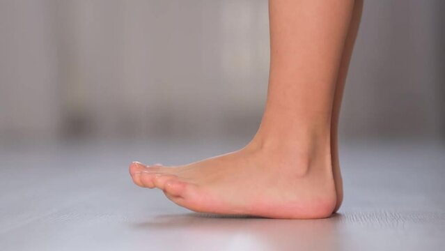 child rolls from heel to toe. Prevention of flat feet in children. Exercises for the legs. Flat feet physical therapy. close up Shot video. Slow motion