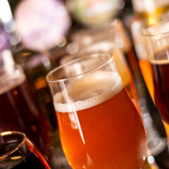 a lot of beers in glass on bar table square