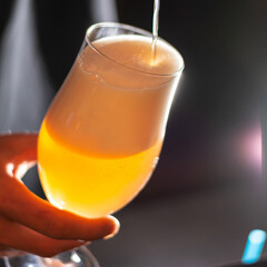 bartender pouring craft beer in to the glass square