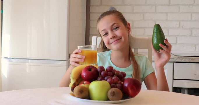 the child eats fruits with pleasure. The girl eats healthy food. the concept of children's health