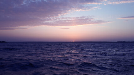 Beautiful landscape on sunrise. Seascape. View on beautiful nature early in the morning. Zen. Trendy Toned in Color of the year 2022, Very Peri.