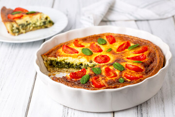 Vegetarian homemade pie, Quiche with tomatoes, spinach and feta cheese, spinach quiche (Turkish name; ispanakli kis)