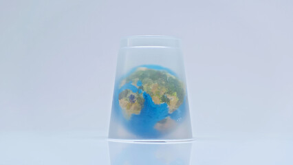 globe covered with plastic cup on grey