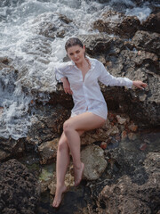 lifestyle swimwear photo-shoot of beautifaul woman on rocky beach