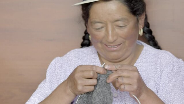 two women knitting and working with wool thread while chatting