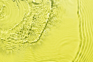 Banner or background for advertising cosmetics with yellow green water spills. Natural sunlight and shade. Beautiful bursts and glare. Summer mood. Minimal style.