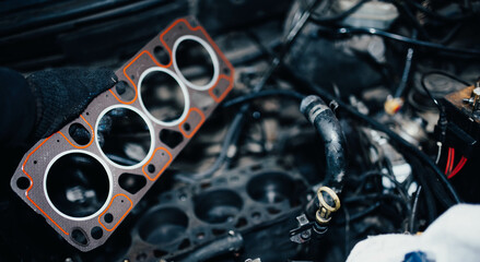 replacement of the cylinder head gasket in the car engine.