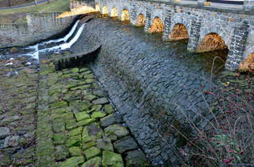 The dam of the breeding fish pond has a canal safety overflow similar to a weir. the water flows...