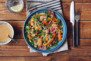 Roasted pepper salad with bacon, quinoa and wild rocket