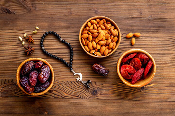 Dates fruits and islamic rosary with star and crescent. Ramadan Kareem concept