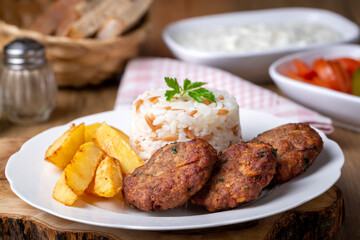 Traditional Turkish food; dry meatballs or inegöl meatballs with potatoes  and rice pilav (Turkish name; Kuru kofte)