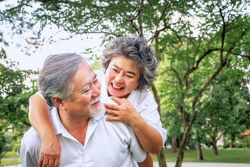 Fototapeta premium relationship elderly couple health care in park, retirement old adult man and woman embracing in love hug and smile, People retirement lifestyle concept.