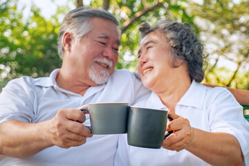 Happy asian elderly couple drink coffee relax in park, relationship retirement, People lifestyle concept.