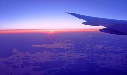 Naklejka na ściany i meble Aerial view Earth planet from the plane. Sunrise, horizon, sky, heaven, air.