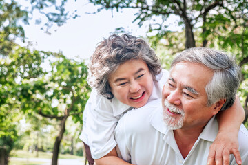 relationship elderly couple health care in park, retirement old adult man and woman embracing in love hug and smile, People retirement lifestyle concept.