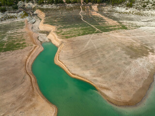 vista de un embalse de agua con niveles de agua bajo mínimos