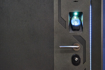 Image of a steel door with a fingerprint scanner.