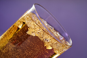 Fruit sparkling water is poured into a glass.