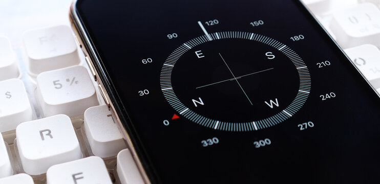 Compass app on smartphone screen - Powered by Adobe
