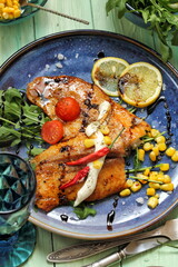 Fried fish in Italian herbs with corn and arugula