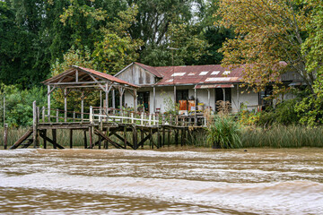 The long-abandonned rusting riverside building with its landing-stage lies beside the Tigre delta...